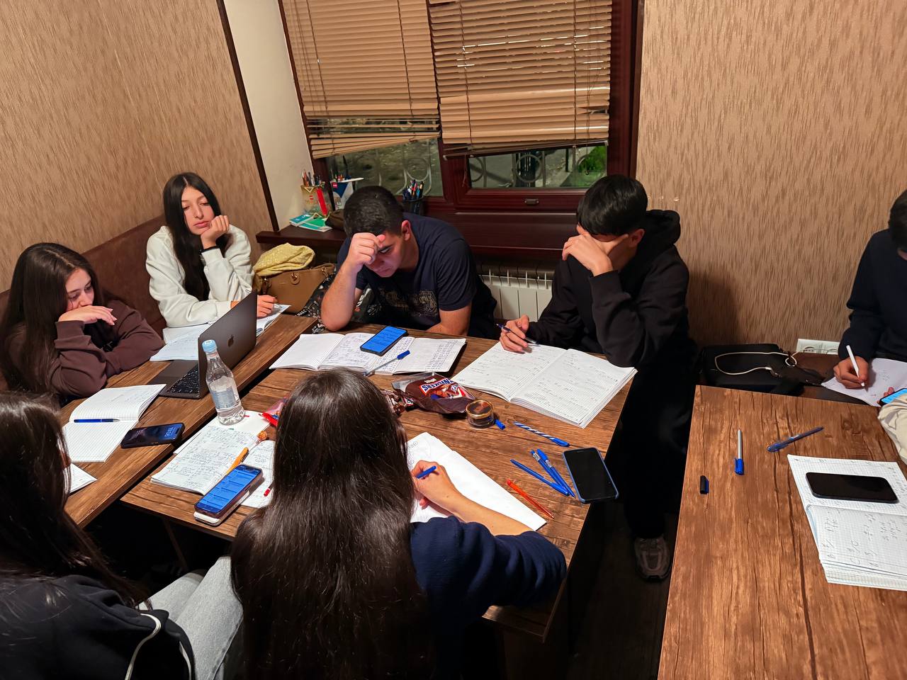 Calm late-evening prep group working on practice tests